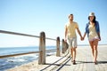 Beach, travel and happy couple holding hands while walking, talking and having fun on summer vacation. Sea, holiday and Royalty Free Stock Photo