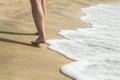 Beach travel - woman walking on sand beach leaving footprints in the sand. Beach travel Royalty Free Stock Photo