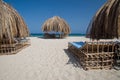 Beach with tropical cabana hut with palm leaves Royalty Free Stock Photo