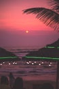 A beach at twilight, surrounded by palm trees and vibrant greenery: Sunset, Da Nang, Vietnam Royalty Free Stock Photo