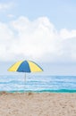 Beach umbrella in beautiful scenery with sand, blue sea and cloudy sky in Trindade, Paraty, Brazil Royalty Free Stock Photo