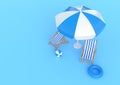 Beach umbrella with chairs and beach accessories on the bright blue background Royalty Free Stock Photo