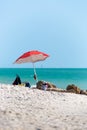 Beach Umbrella With A Green Water Sea In Naples, Florida