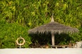 Beach Umbrella made of palm leafs on the background of an exotic