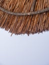 Beach umbrella made of reeds on the Greek island on a Sunny summer day Royalty Free Stock Photo