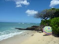 Beach Umbrella on Makalei Beach with waves lapping on shore Royalty Free Stock Photo