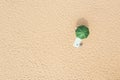 Beach umbrella near towel and other vacationist`s stuff on sand, aerial view. Space for text Royalty Free Stock Photo