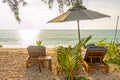 Beach umbrella and sunbath seats on Pak Weep beach in the evening