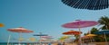 Beach with umbrellas and chairs on the golden sand under sunlight against a blue sky Royalty Free Stock Photo