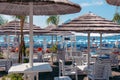 Beach umbrellas, chairs, table. Places to relax by the sea. The concept of quarantine and the beginning of the tourist season,