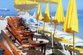 Beach umbrellas and chaise for relax and comfort on sea coast. Happy summer vacations and tourism concept. Paid service on