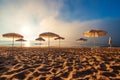 Beach with umbrellas. Foggy morning over the sea Royalty Free Stock Photo