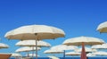 Beach umbrellas, gazebos and sun beds at Italian sandy beaches. Adriatic coast. Emilia Romagna, Itsly Royalty Free Stock Photo