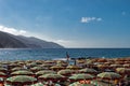 Beach umbrellas on an italian beach in Monterosso Royalty Free Stock Photo