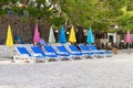 Beach umbrellas and loungers for relax and comfort on sea beach. Happy summer vacations and holiday concept. Paid service on