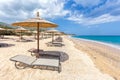 Beach umbrellas in rows on sandy beach with sea Royalty Free Stock Photo