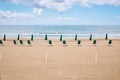 A beach with umbrellas and sun beds on coast