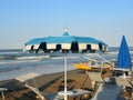 Beach umbrellas and sun beds at Italian sandy beaches. Adriatic coast. Emilia Romagna region Royalty Free Stock Photo