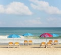 Beach umbrellas and sunbeds on the background of the sea