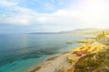Beach with umbrellas sunbeds on coast of Crete, with people resting. Hersonissos, Crete.