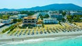 beach with umbrellas and sunbeds resort Rhodes, Greece, panoramic drone views of the black sea, coast and the island