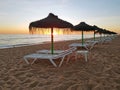 Beach umbrellas at sunset on Aruba island Royalty Free Stock Photo