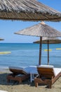 Beach unbrellas and chairs on sunny sandy beach Lady`s mile in Akritori, Cyprus