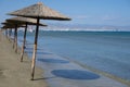 Beach unbrellas and chairs on sunny sandy beach Lady`s mile in Akritori, Cyprus