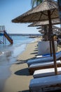 Beach unbrellas and chairs on sunny sandy beach Lady`s mile in Akritori, Cyprus