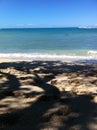 On the beach under shady tree at Kekaha Kai state park