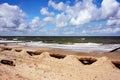 Beach in Ustronie Morskie resort in Poland, a big rusty pipe on the sandy beach in the foreground Royalty Free Stock Photo