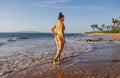 Beach vacation. Beautiful woman in bikini enjoying view of beach ocean on summer day, Hawaii. Royalty Free Stock Photo
