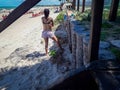 Beach vacation. Beautiful woman in bikini standing enjoying the beach on summer day. Pernambuco, Brazil