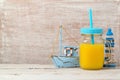 Beach vacation concept with orange juice and nautical decorations