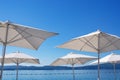 Beach vacation concept. White sun umbrellas on blue sky background. Montenegro. Copy space Royalty Free Stock Photo