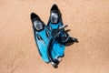 Beach vacation fun snorkel equipment on sand with ocean waves splashing water. Scuba diving and snorkelling. Black Flippers, black Royalty Free Stock Photo