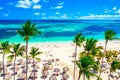 Beach vacation and travel background. Aerial drone view of beautiful atlantic tropical beach with straw umbrellas, palms and boats