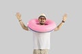 Funny traveler or tourist man wearing inflatable ring studio headshot portrait