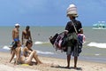 Beach vendor and female sunbathers on beach