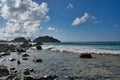 Beach view with rocks, blue sky and seashore