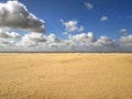 Beach view with sand and cloudy blue sky. Picture taken in Oostende, Belgium.