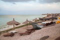 Beach view with shipwreck and reed shelters Royalty Free Stock Photo