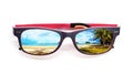 Beach view on sunglasses on white background.