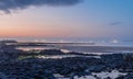 Beach of volcanic rocks at sunset Royalty Free Stock Photo