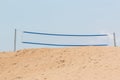 Beach volley net on sand dune with sky. Royalty Free Stock Photo