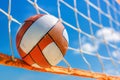 Beach volleyball with ball and net on sunny beach, summer sea recreation and leisure concept Royalty Free Stock Photo