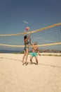 Beach volleyball concept. Couple have fun playing volleyball. Young sporty active couple beat off volley ball, play game Royalty Free Stock Photo