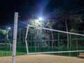 Beach volleyball court in the evening. Available infrastructure. Empty sports ground. Volleyball game concept. Sports mesh.