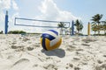 A beach volleyball net on a sunny beach, with palm trees Royalty Free Stock Photo