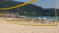 Beach volleyball, sand and protective umbrellas